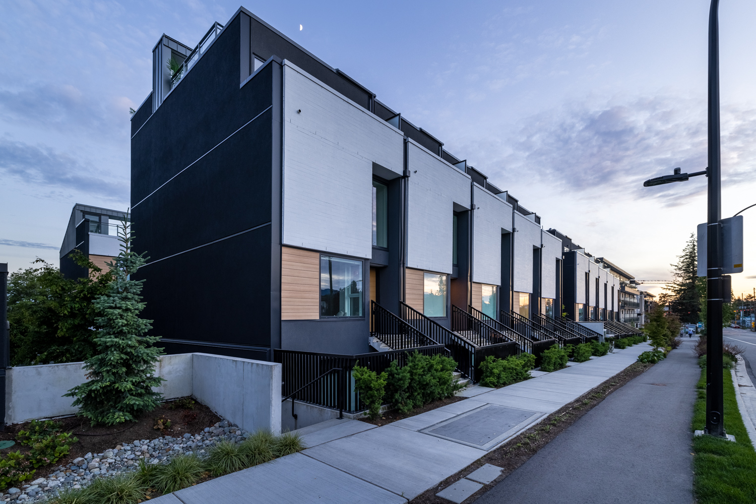 40 thoughtfully designed modern townhouses and garden suites, each with own front door Dististince London-Inspired West Coast Modern Design by Shape Architecture, accented with white brick, grey metal detailing and cedar finishes 